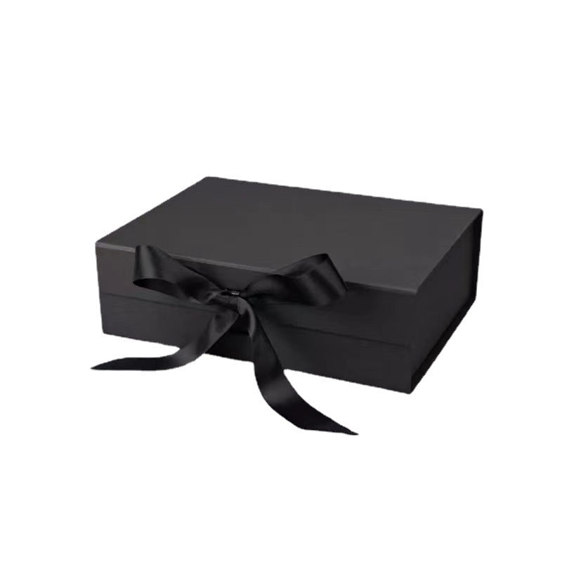 Black gift box with a black ribbon on a white background