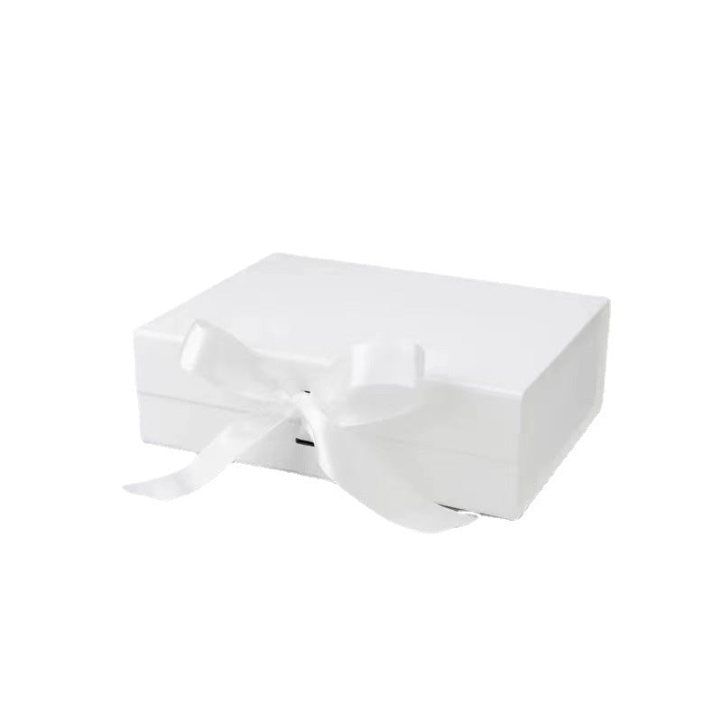 White gift box with a bow on a white background